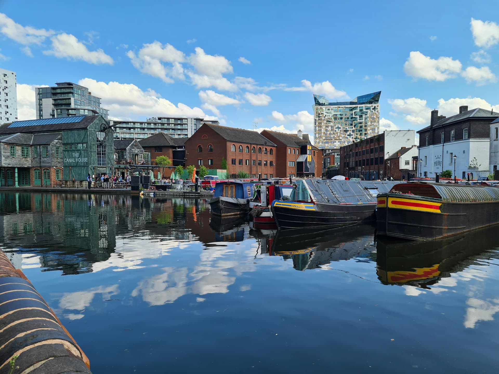 Narrowboats on a Birmingham canal with the Bullring beyond.