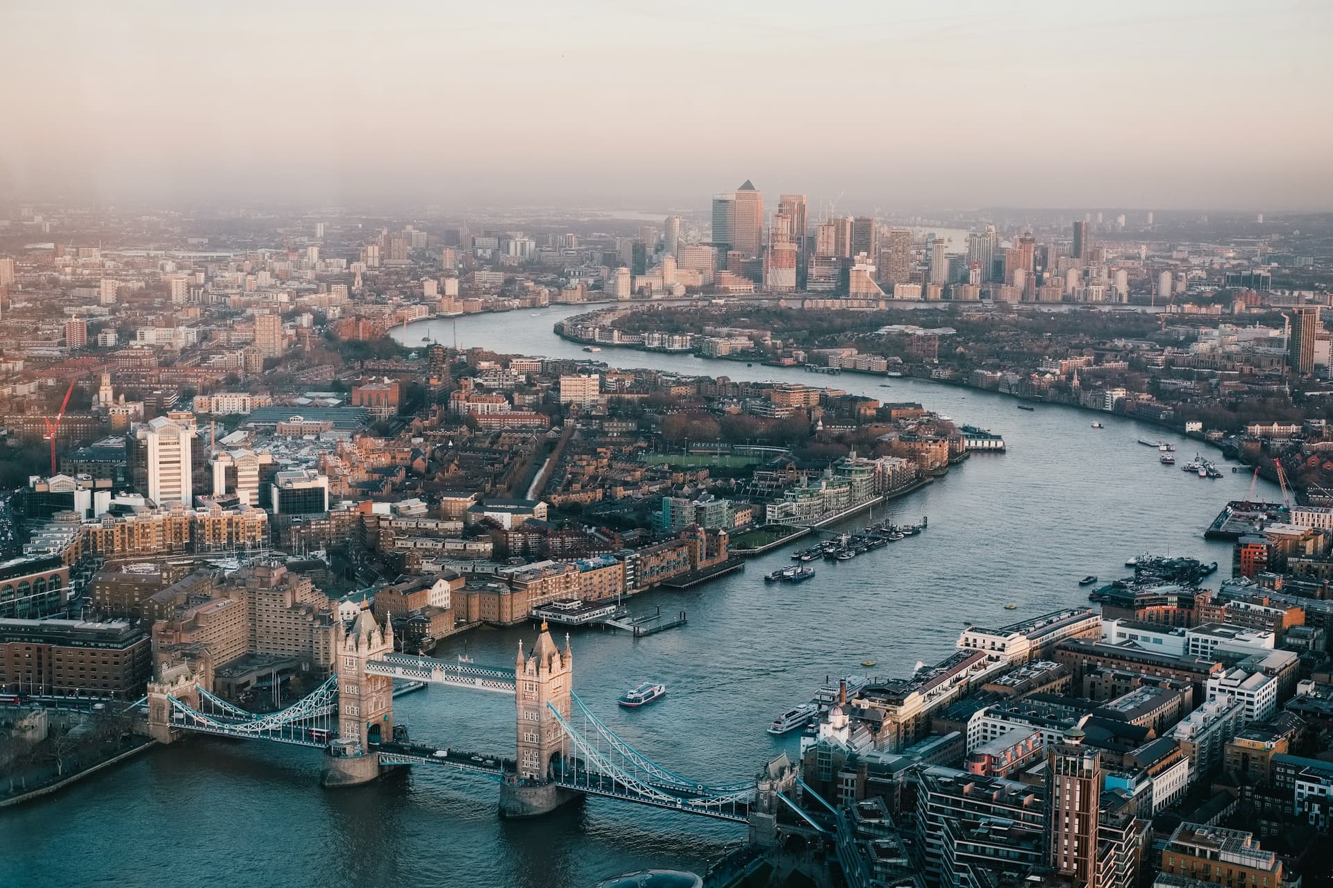 Aerial view of Tower Bridge and the Thames at dusk.