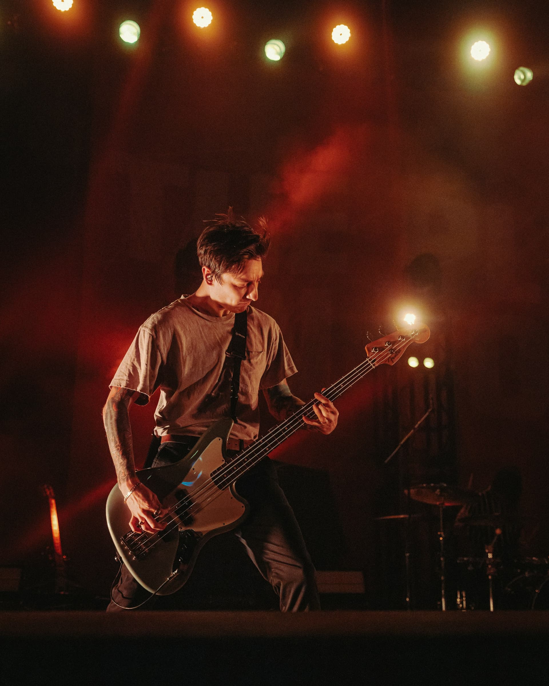 A bassist playing on stage.