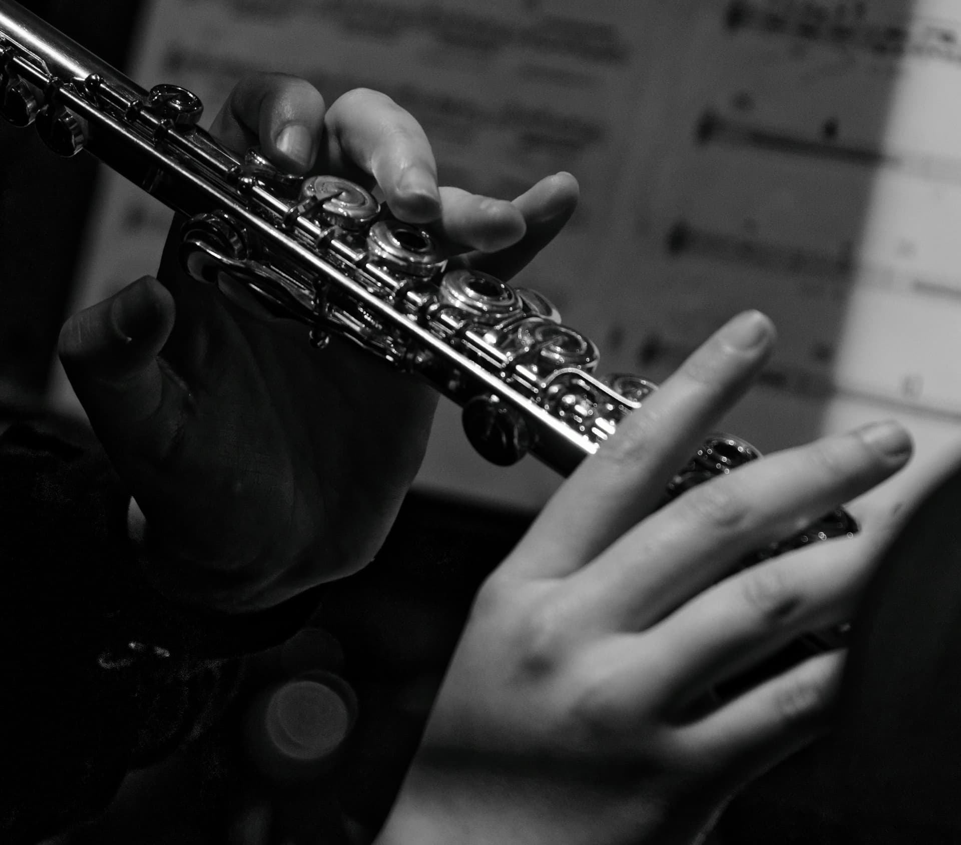 Close-up of a flautist's hands on the keys.