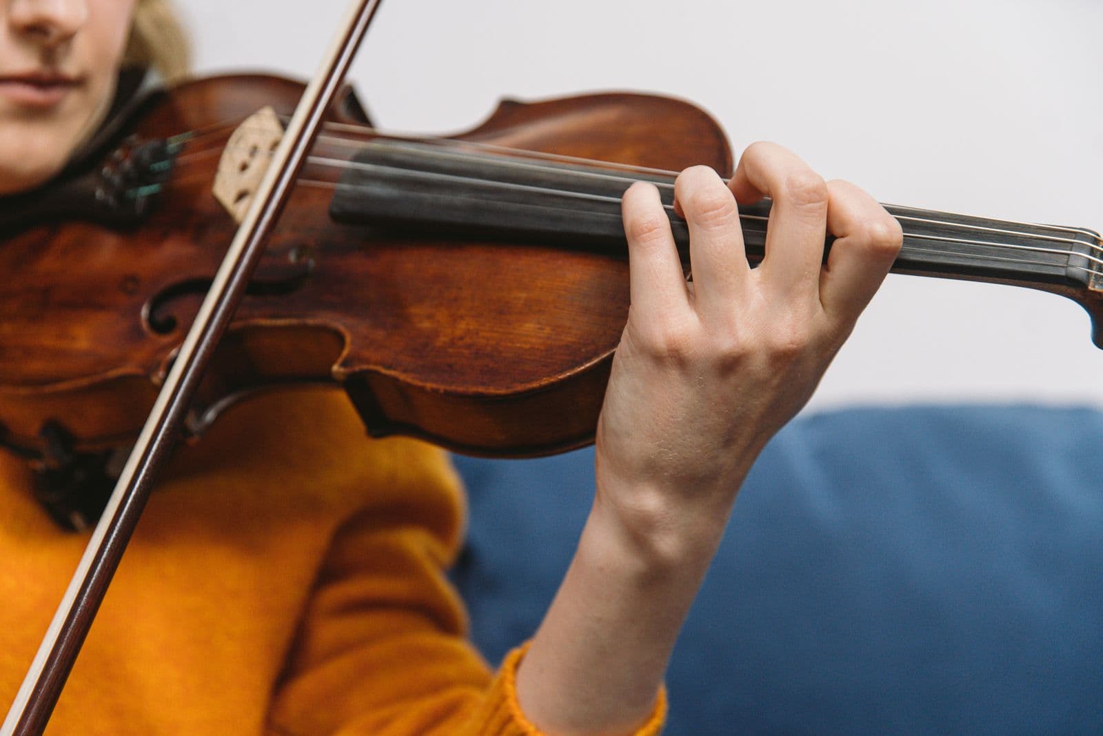 Close-up of a string player's fingers on the fingerboard.