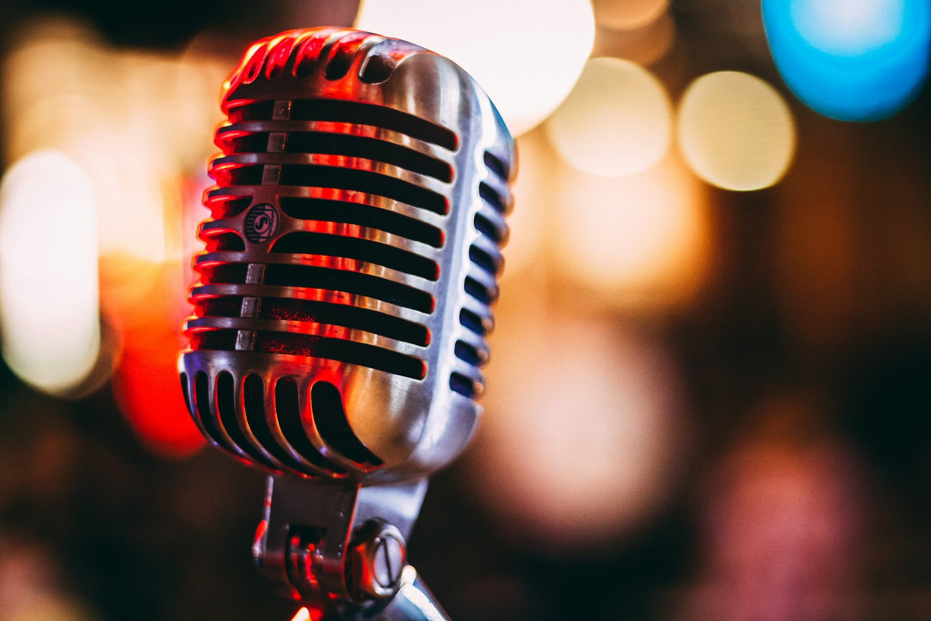 A vintage microphone in warm stage light.