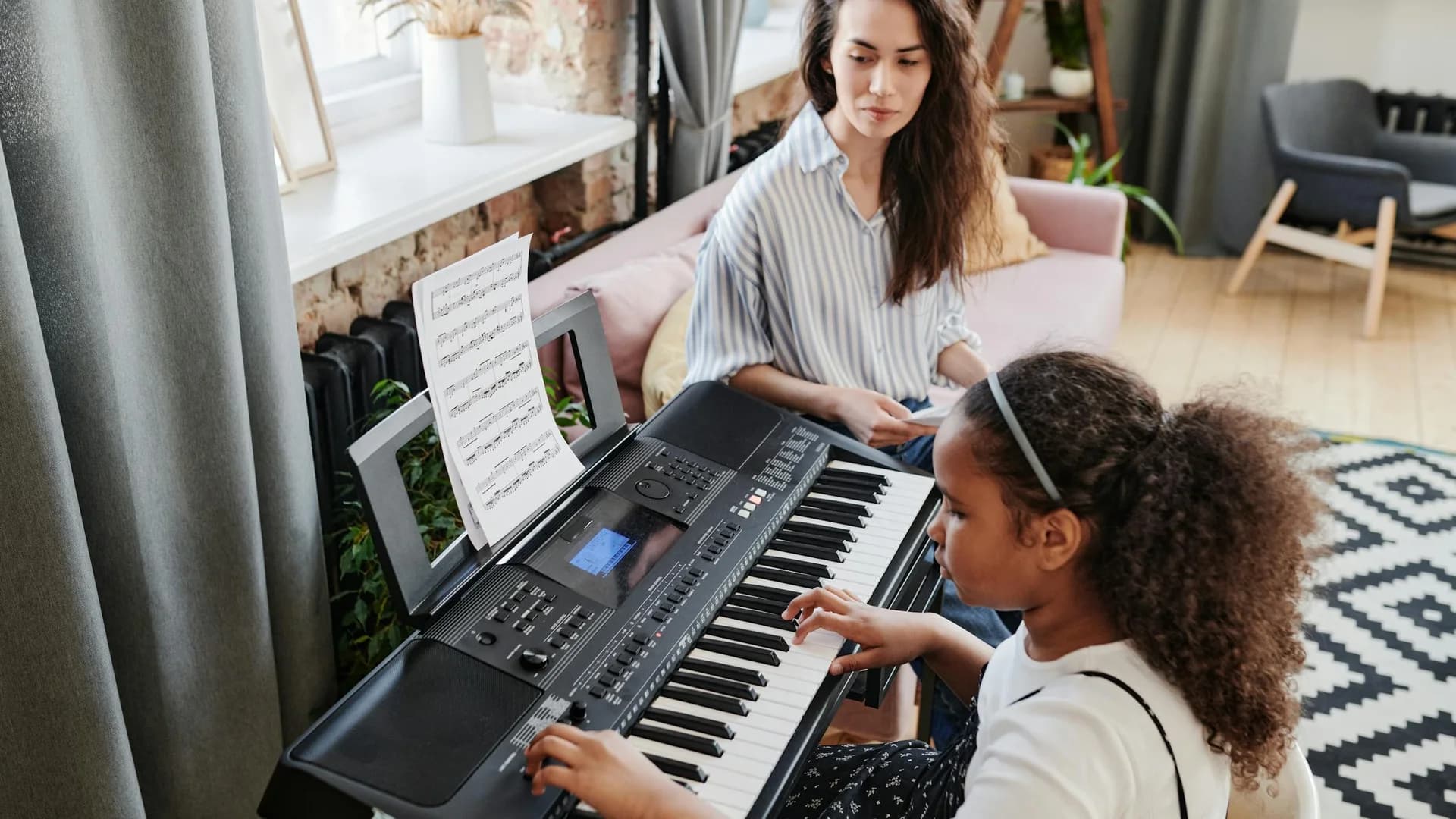 A music teacher guiding a student through a piano lesson.