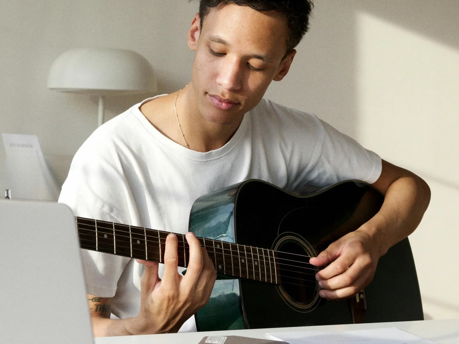 A guitar student reviewing lesson details before making a decision.