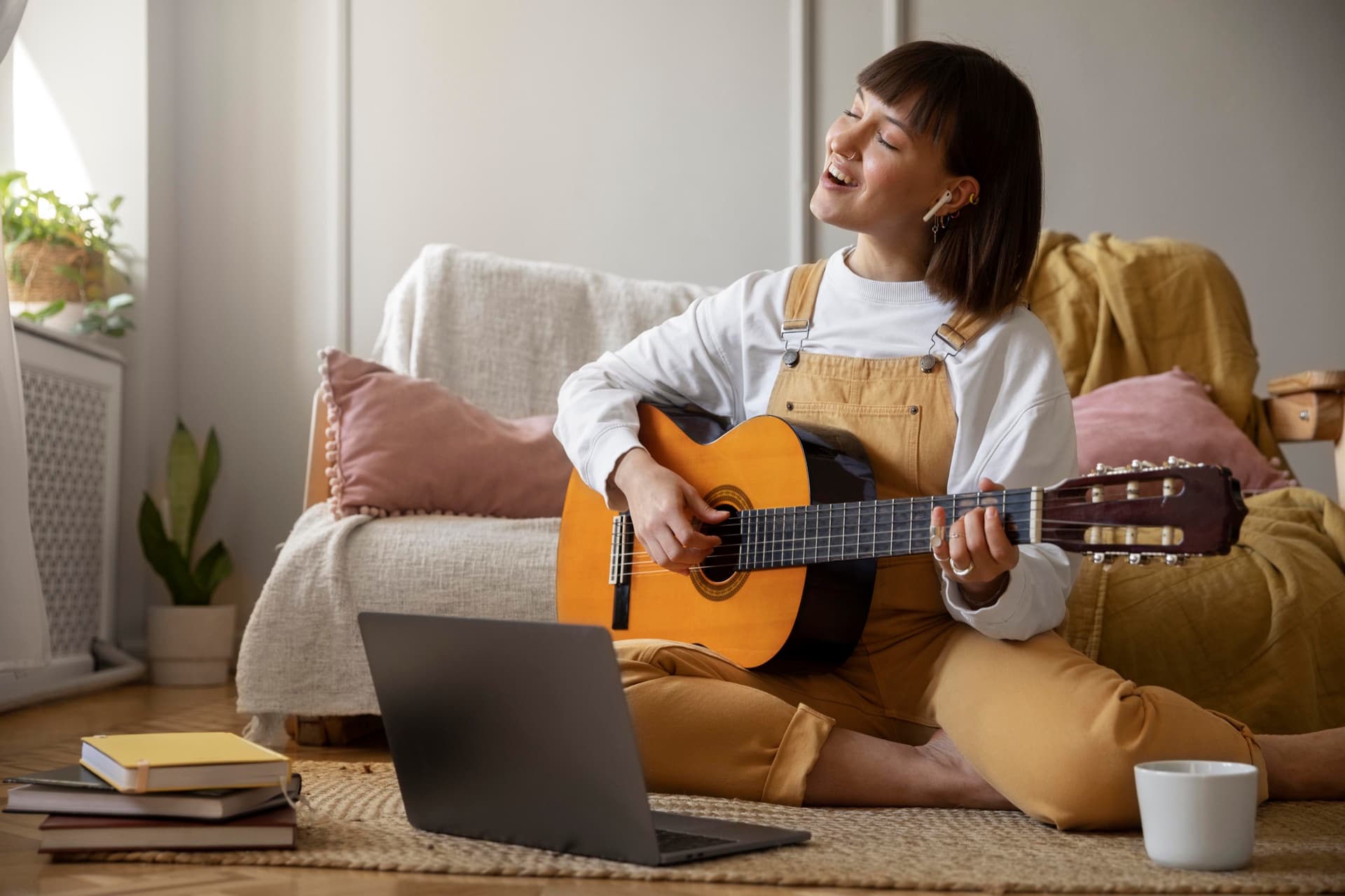 A guitarist playing relaxed at home.